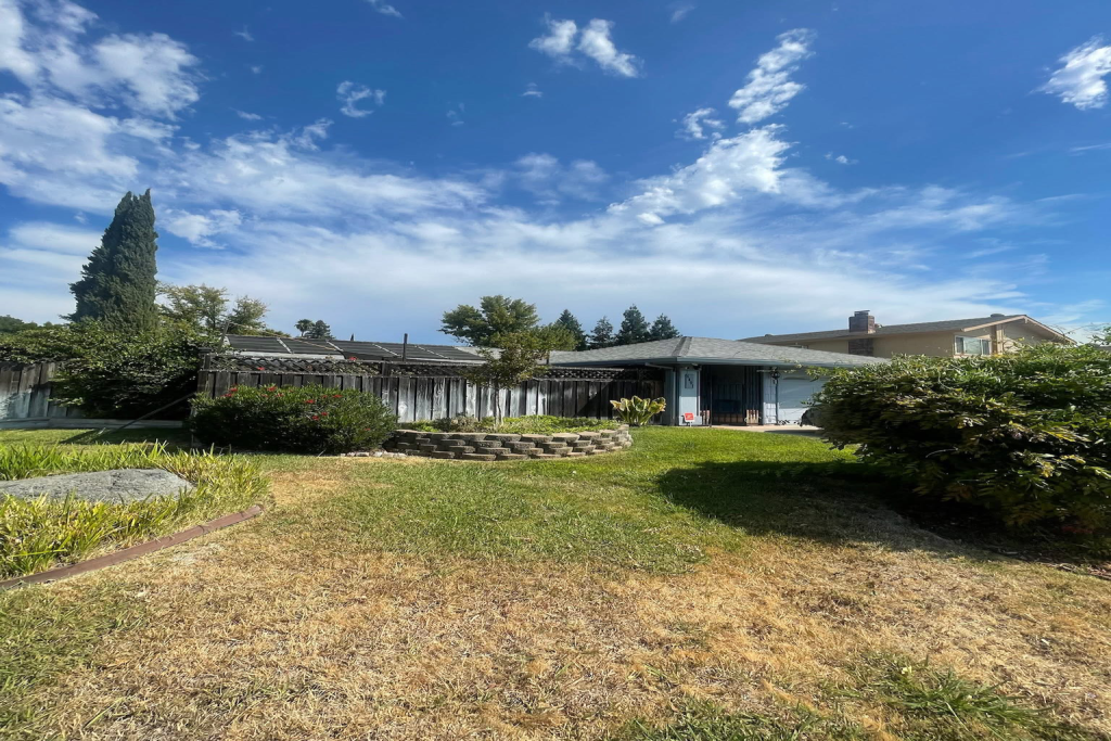 Residential backyard view of a home prior to selling decision