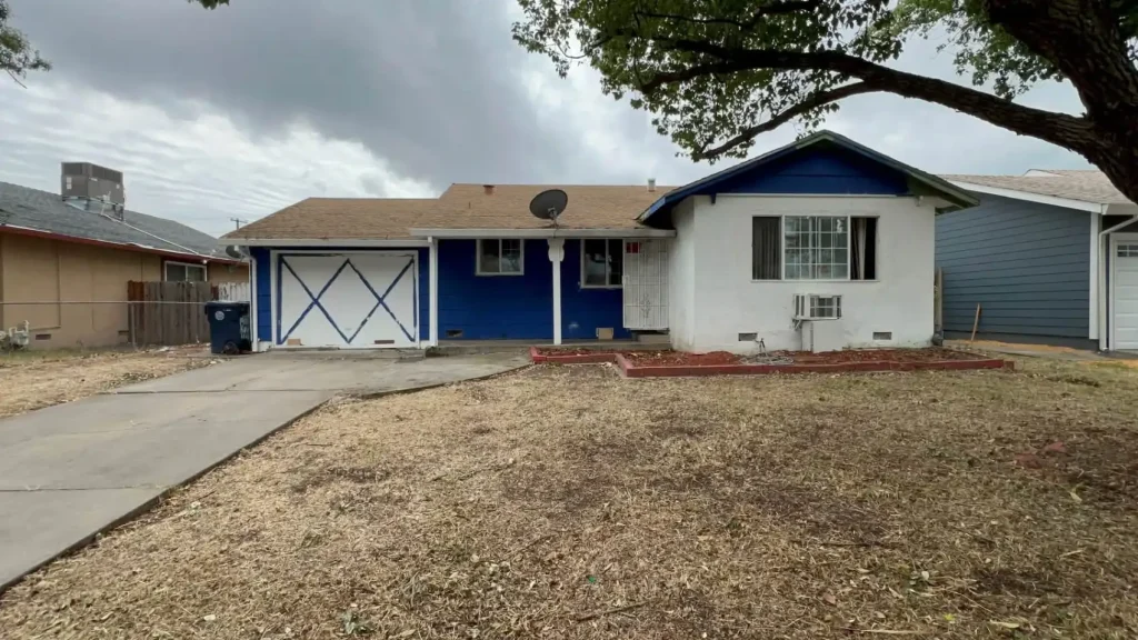 House exterior with driveway and front yard